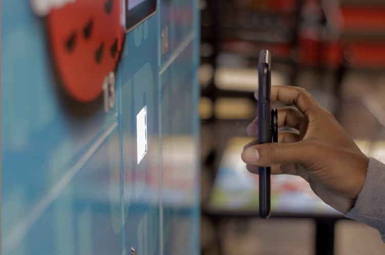 A customer scanning a QR code from a mobile phone to open the Lavii smart food locker.